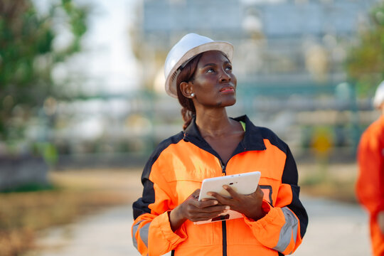 Maintenance engineer inspecting industrial plant with digital tablet while evaluating equipment condition. Technical assessment, preventive maintenance, engineering support and operational safety.