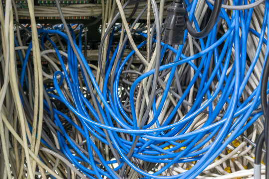 Tangled network ethernet cables connected server rack illustrating data communication infrastructure information technology maintenance connectivity challenges