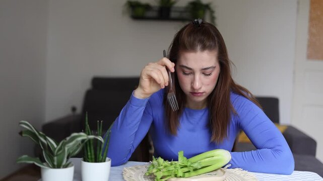 Every meal feels like a difficult test as young woman silently fights obsessive calorie thoughts unable to enjoy food because fear always comes before appetite