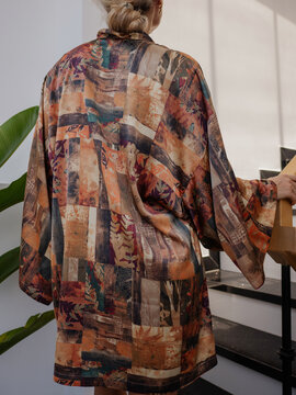 Elegant woman wearing luxury kimono robe in modern tropical home
