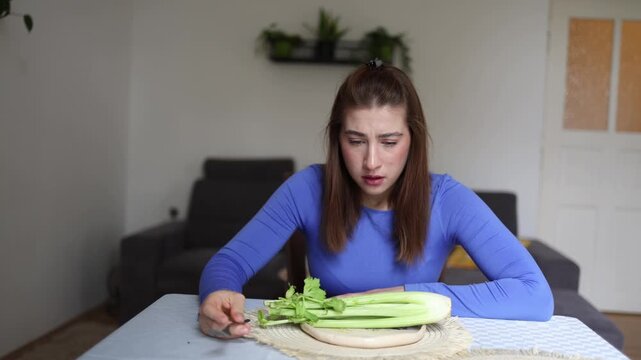 Healthy eating turns into silent suffering as young woman stares at celery revealing disordered eating obsessive calorie thoughts and growing emotional exhaustion