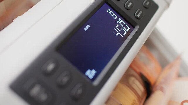 Close-up of Money Counting Machine Processing 50 Euro Banknotes