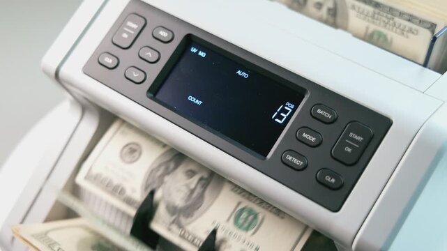Close Up Money Counting Machine Processing US One Hundred Dollar Bills