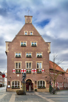 Kiepenkerl monument, Munster, Germany, scenic square view. Famous bronze peddler statue and red brick building facade