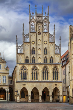Historical City Hall, Munster, Germany, facade view. Beautiful medieval gothic rathaus building under daytime cloudy sky