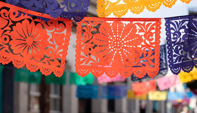 Colorful Mexican papel picado banners. Traditional floral paper cutouts for celebration.