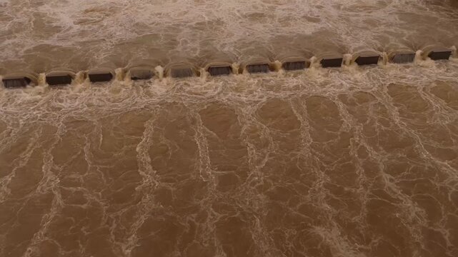 Aerial drone view of Surat Causeway overflow with powerful monsoon water flow across river barrage in Gujarat India