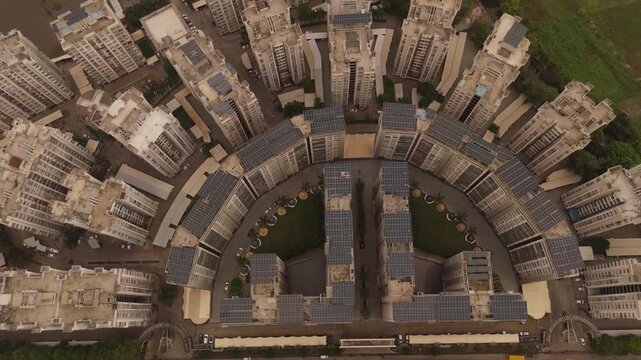 Aerial top view of modern residential apartment complex with rooftop solar panels and sustainable urban architecture in Surat India