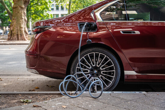 Ein E-Auto wird an einem Ladebordstein auf der K&Ouml; mit einem Kabel aufgeladen, D&uuml;sseldorf, Deutschland
