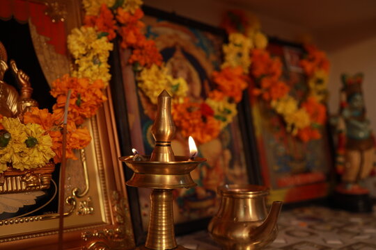 Traditional brass oil lamp lit with warm glowing flames during Indian religious festival puja