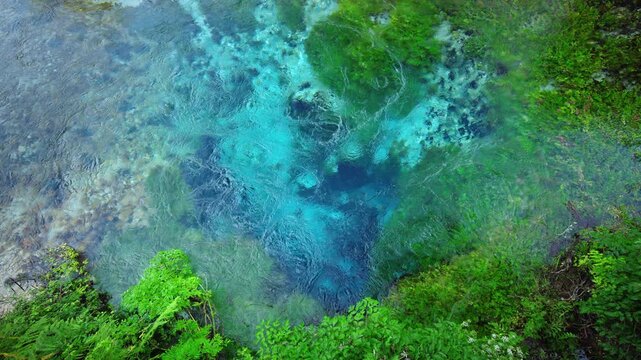 Crystal clear waters of the Blue Eye spring in southern Albania reveal vibrant turquoise colors and underwater karst formations surrounded by lush vegetation