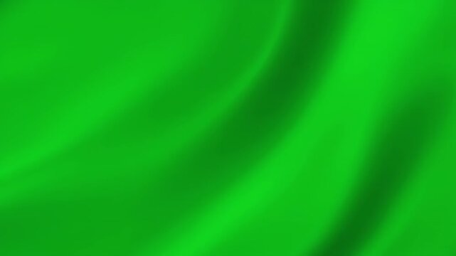 Vibrant green fabric flowing smoothly with gentle waves during a soft studio lighting for abstract backgrounds