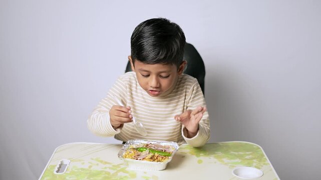 Indian boy eating healthy food. Child having lunch at home in Delhi NCR.