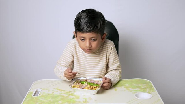 Indian boy eating healthy food. Child having lunch at home in Delhi NCR.