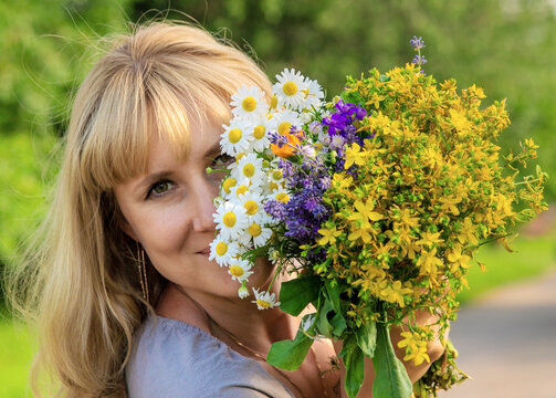 Woman with medicinal herbs. Selective focus.