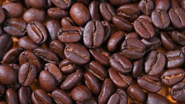 Close-up of premium roasted coffee beans with rich brown color and natural texture. Fresh aromatic coffee beans suitable for coffee, caf&eacute;, beverage, roasting, caffeine, and food background concepts.