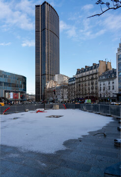 Tour Montparnasse overlooking an urban greening project during light snowfall in Paris highlighting climate adaptation and nature based solutions in a climate resilient city