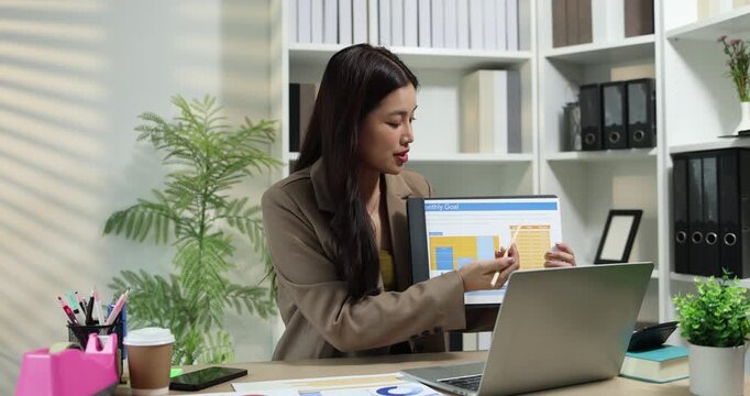 Businesswoman presenting financial reports and performance charts during business meeting, explaining data analysis, company results and strategic planning for finance, management and corporate growth