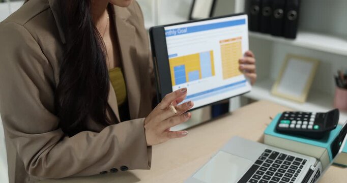 Businesswoman presenting financial reports and performance charts during business meeting, explaining data analysis, company results and strategic planning for finance, management and corporate growth