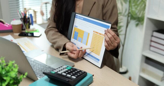 Businesswoman presenting financial reports and performance charts during business meeting, explaining data analysis, company results and strategic planning for finance, management and corporate growth