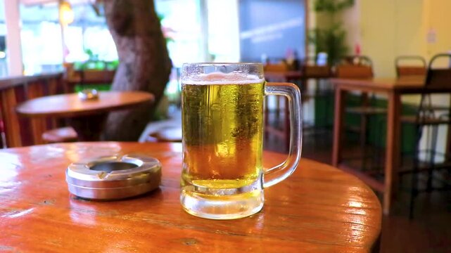 Cold Beer Glass Mug On Bar Table With Ashtray Lifestyle Thailand.