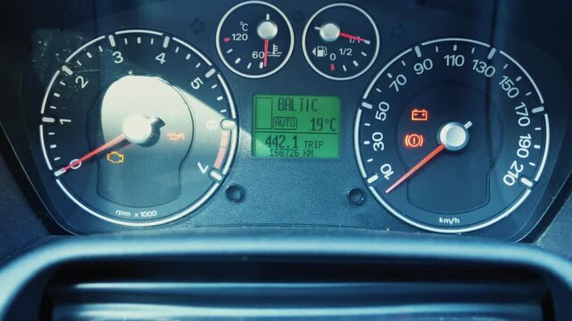 Car ignition turned on with dashboard gauges and speedometer