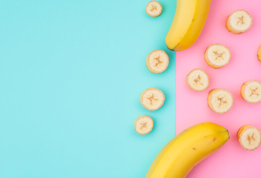 sliced bananas on pastel background. flat lay