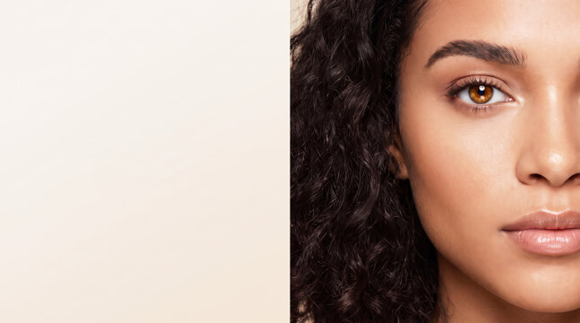 Beautiful mixed race woman half face portrait with copy space on beige background