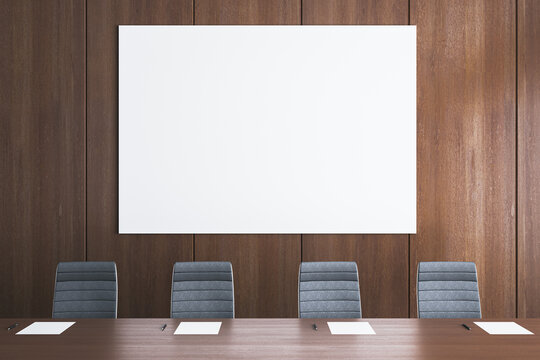 Blank White Poster Mockup on Wooden Conference Room Wall with Chairs, Papers, and Pens for Corporate Presentation Design. 3D Rendering