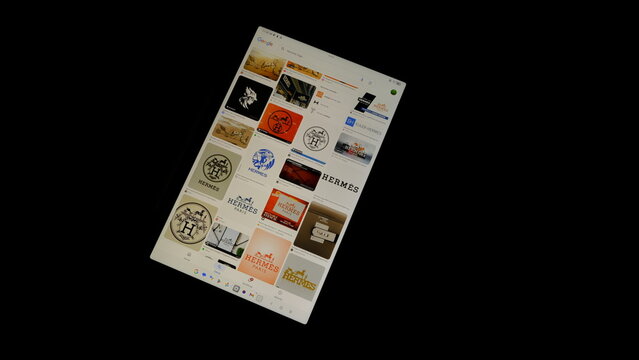 Tablet screen view with various sized Hermes logos, on a black background, August 1, 2026