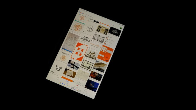 Tablet screen view with various sized Hermes logos, on a black background, August 1, 2026