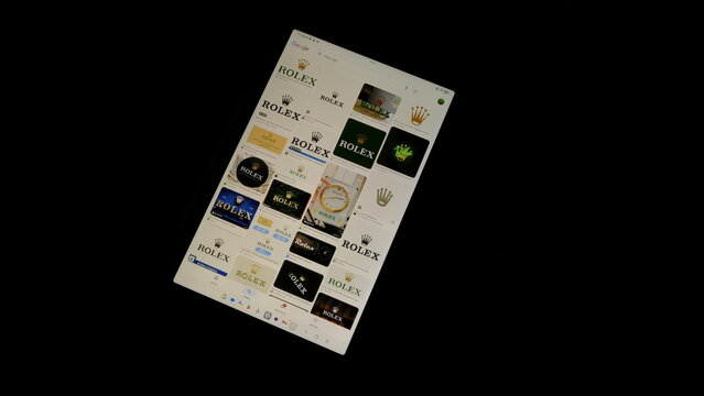 Tablet screen view with various sized Rolex logos, on a black background, August 1, 2026
