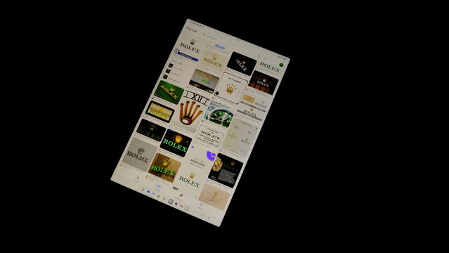 Tablet screen view with various sized Rolex logos, on a black background, August 1, 2026