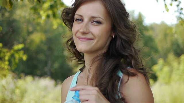 young dark-haired woman drinking water