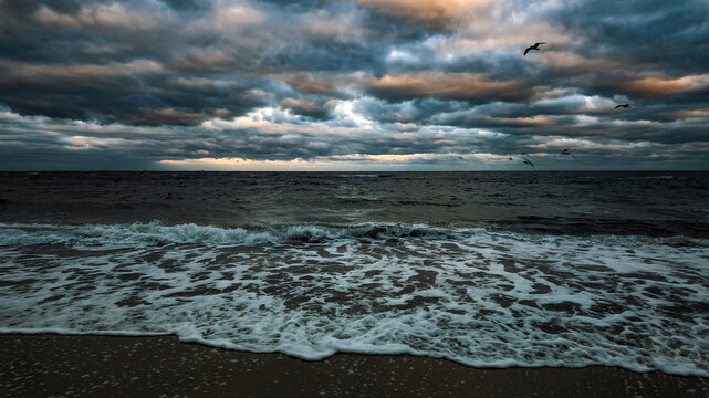 Stormy sea with seagulls dramatic clouds