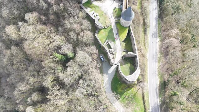 Top down aerial view over historic Chateau de Bourscheid stone castle ruins Luxembourg