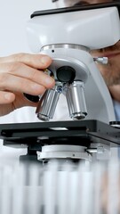 Naklejka premium Scientist wearing protective mask and gloves examining samples beneath a microscope, performing detailed research in a laboratory exploring biology and medicine