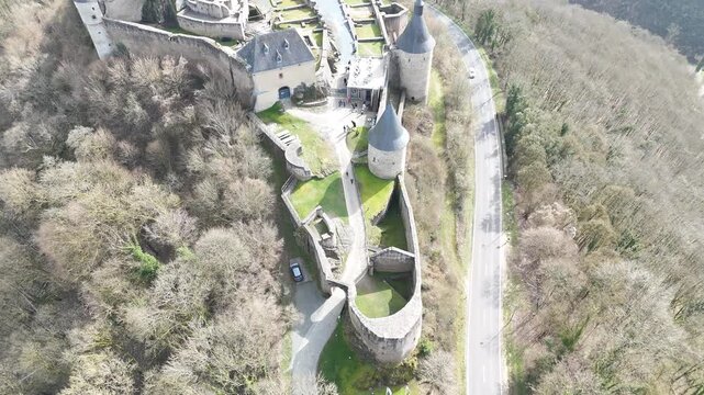 Cinematic drone flyover and forward approach over stone ruins of Bourscheid Castle