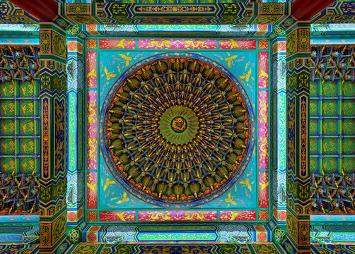 Intricate, vibrant, and ornate ceiling with traditional Chinese motifs and circular designs inside Thean Hou Temple, a beautiful landmark located in Kuala Lumpur, Malaysia