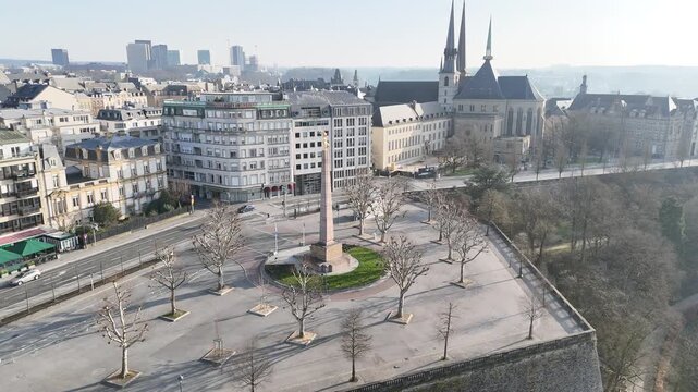 Aerial parallax panning view rotating around historic Golden Lady monument in Constitution Square