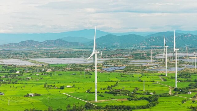Drone flight over Dam Nai Wind Farm and green rice fields in Khanh Hoa, Vietnam