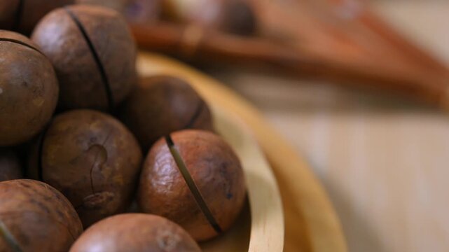 Roasted macadamia nuts with a golden brown colour and crunchy texture. Premium healthy snack rich in healthy fats and nutrients, ideal for healthy eating, baking, cooking, and food photography concept