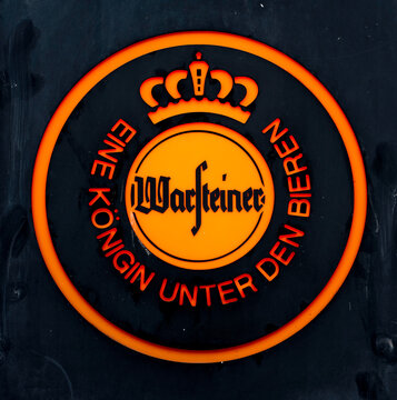 Warsteiner illuminated brewery logo on dark background
