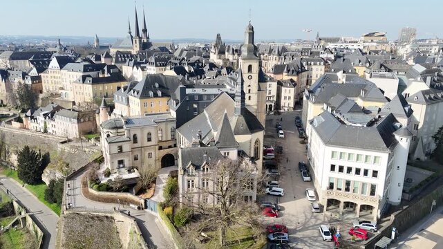 Drone 180 degree pan left revealing Eglise Saint Michel church in Luxembourg City