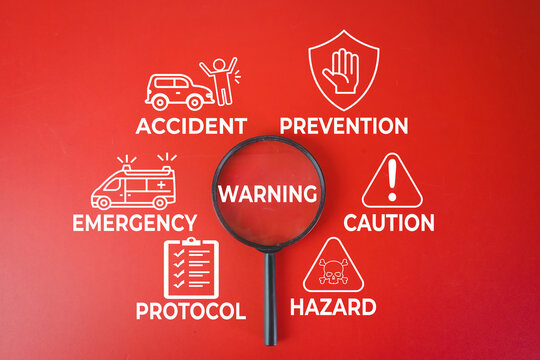 Risk management and safety concept. Magnifying glass focusing on WARNING text surrounded by accident, prevention, emergency, caution, hazard and protocol icons on red background.