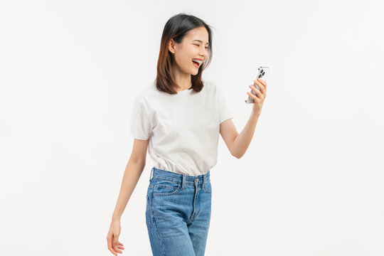 Smiling young Asian businesswoman using smartphone and chatting online isolated on white studio background for communication.