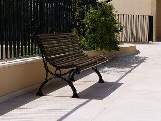 A calm, Mediterranean terrace scene featuring a park bench, ideal for public space design, urban park themes, relaxation, and travel visuals. © Ena