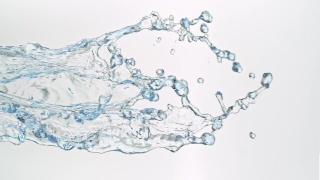 Super Slow Motion Shot of Flying Water Splashes Isolated on White Background at 1000fps.