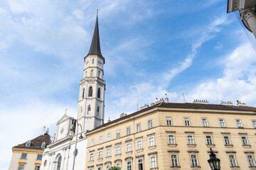 Obraz premium St Michael Church Tower and Historic Facade View at Michaelerplatz Square in Central Vienna Austria