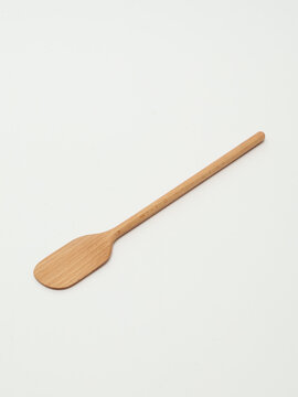 Wooden cooking spatula with long handle isolated on white background